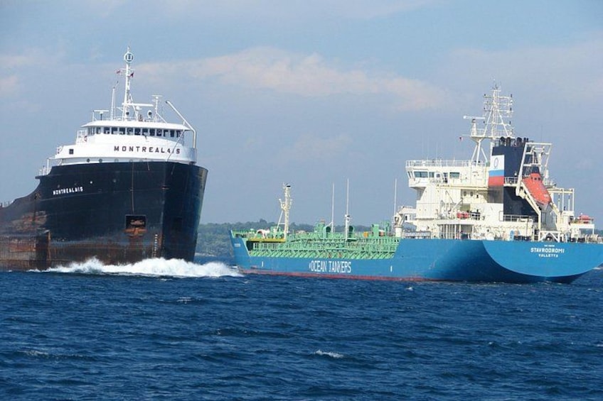 Two large cargo ships on the water, one labeled 'MONTREAL' and the other 'ST. LOUIS.' 5