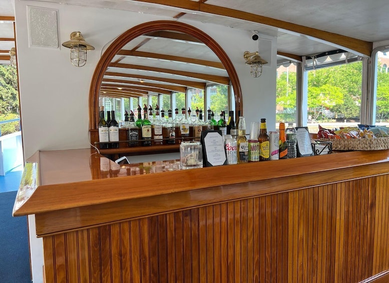A bar with a wooden counter and a large arched window. 1