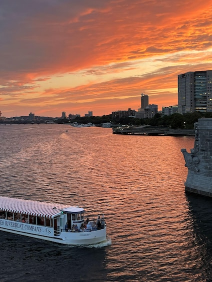 A riverboat named 'Charleston' with passengers, a sunset sky, and a city skyline in the background. 2