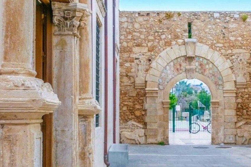 An old stone archway with a bicycle parked in front. 3