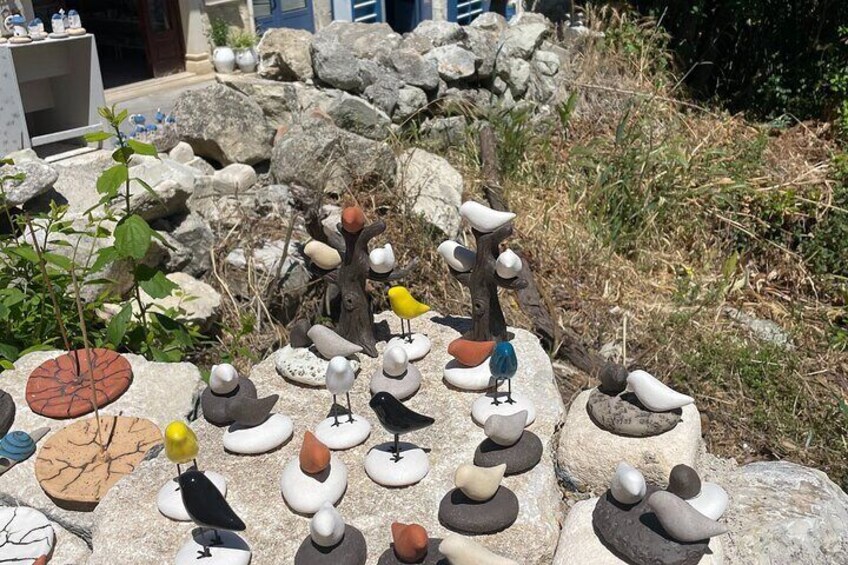 A garden with rocks and bird sculptures. 4
