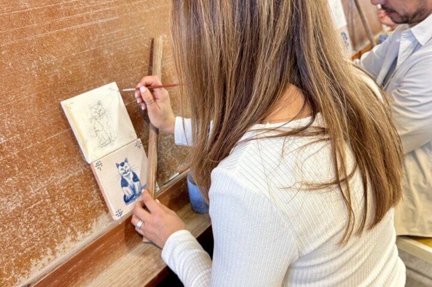 A person painting a portrait on a canvas. 5