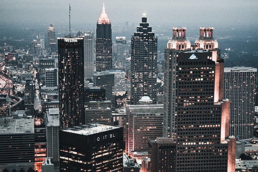 A cityscape with prominent skyscrapers, including a building labeled 'WESTIN' and another with 'IT BL' on its facade. 2