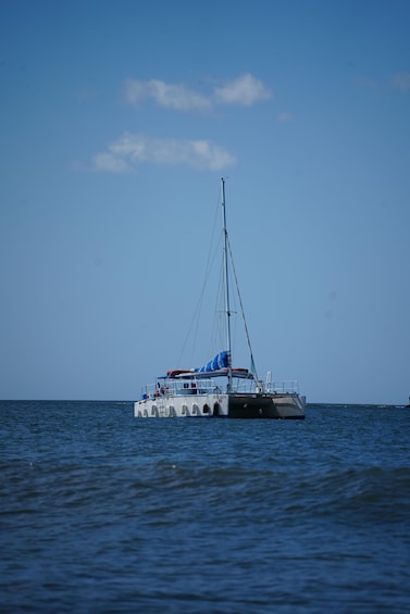 A sailboat on calm water under a clear sky. 3