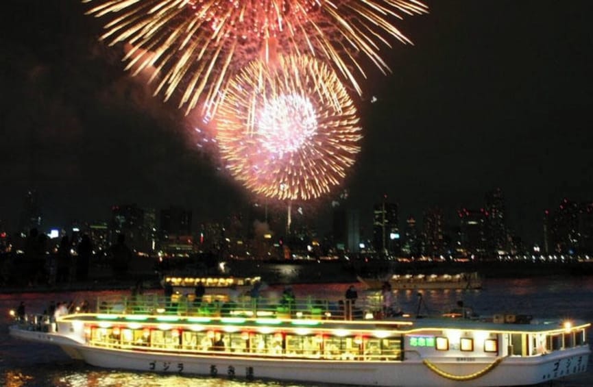 A boat with illuminated windows and a city skyline in the background. 5