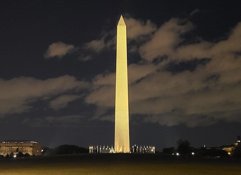 El Monumento a Washington de noche, con cielo oscuro y nubes. 3