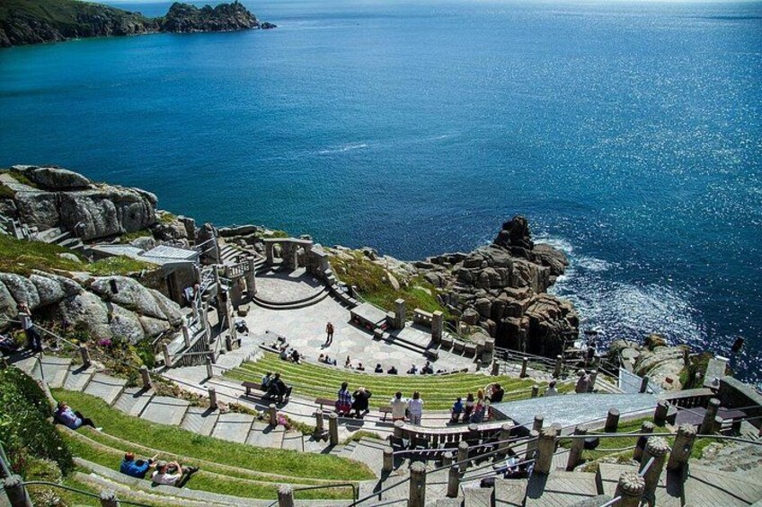 A coastal amphitheater with a circular stage surrounded by stone seating. 2