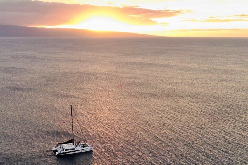 A sailboat on calm waters during sunset. 4