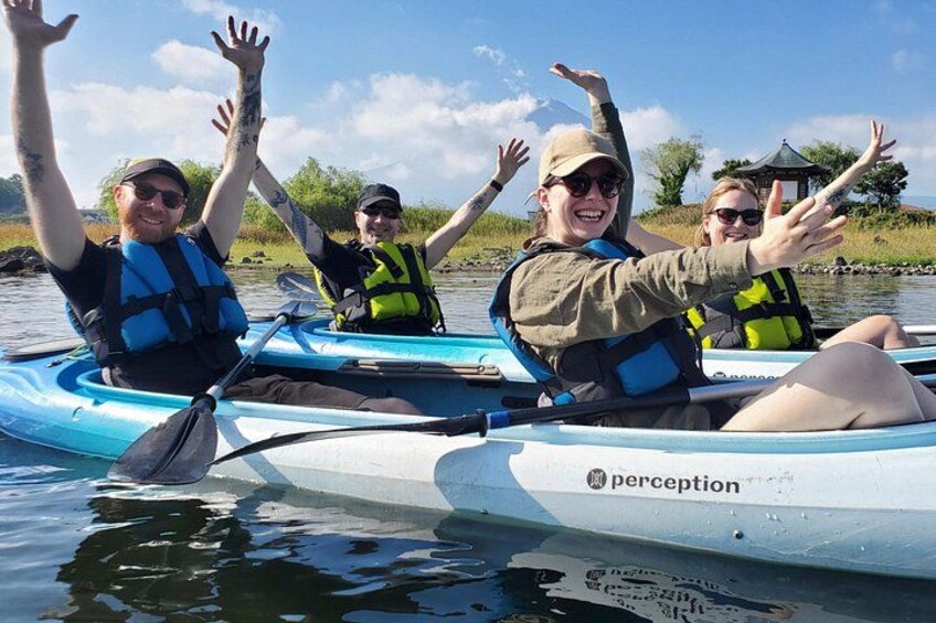 People kayaking on a calm river, wearing life jackets and paddles. 5