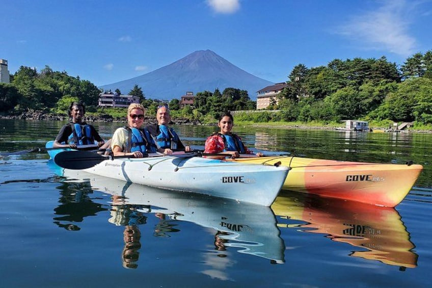 Three canoes on a calm lake with a mountain in the background. 3