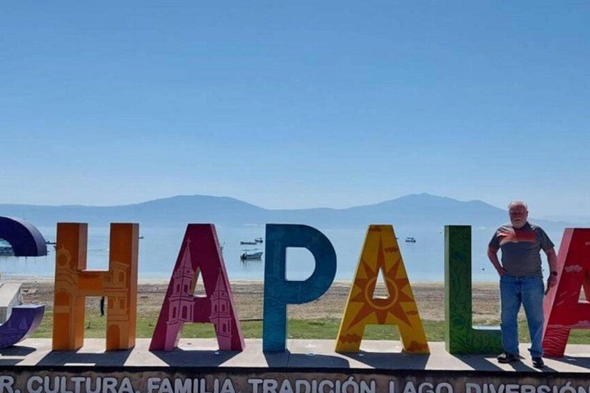 Colorful letters spelling 'CHAPAL' with a man standing in front. 4