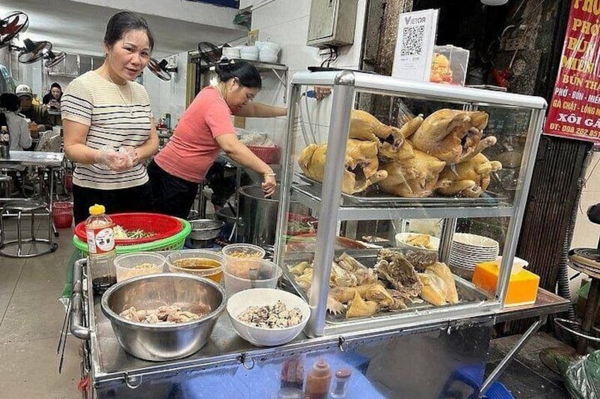 A food stall with various dishes and cooking utensils. 5