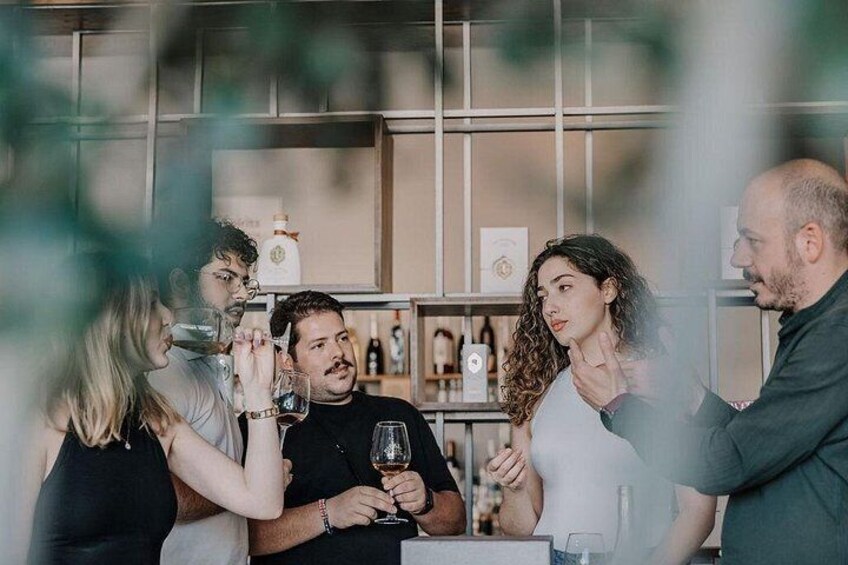 A group of people at a bar with bottles and glasses. 2