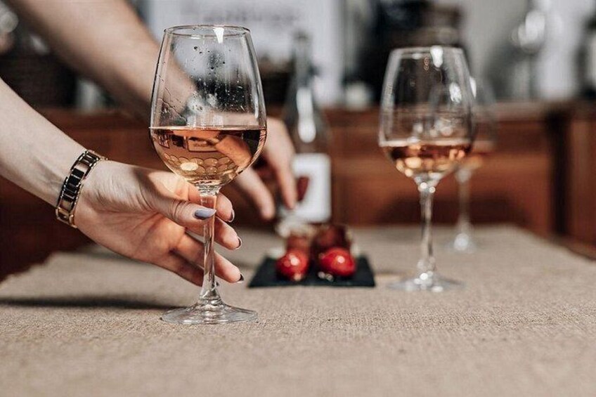 Two wine glasses on a table with a blurred background. 5