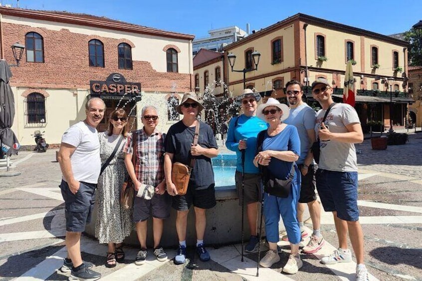 A group of people posing in front of a building with a sign that reads 'CASPER.' 2