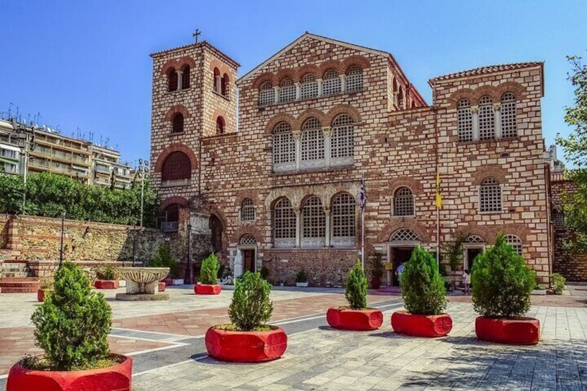 A historic building with a red brick facade and arched windows. 4
