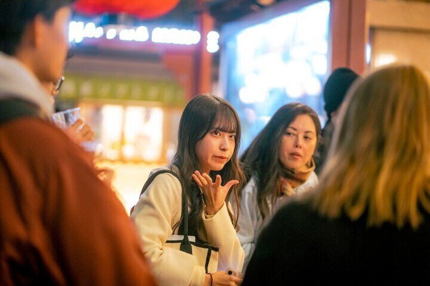 A group of people sitting at a table in a restaurant with a blurred background. 2