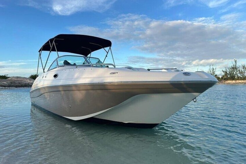 A motorboat on calm water with a clear sky. 3
