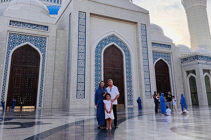 A mosque with blue-tiled arches and a minaret. 2