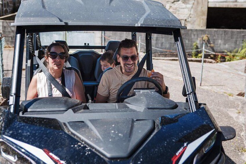 A golf cart with three passengers. 1