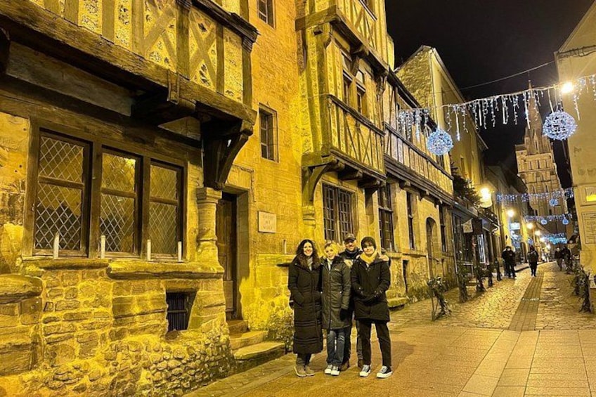 A historic street with buildings, a paved walkway, and decorative lights. 2