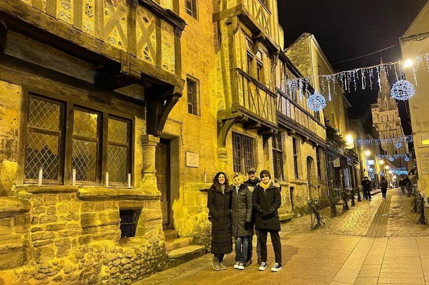 A historic street with buildings, a paved walkway, and decorative lights. 2