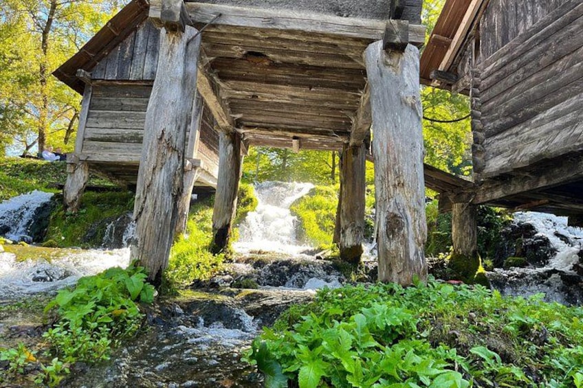 A rustic wooden structure with a waterfall in the background. 2