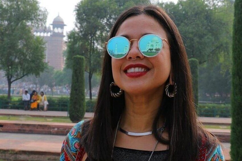 A person in a park with a building in the background. 2