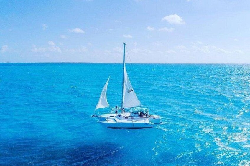 A sailboat on a calm sea with clear skies. 1
