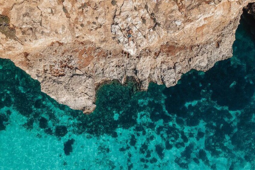 A rocky coastline with clear turquoise waters. 3