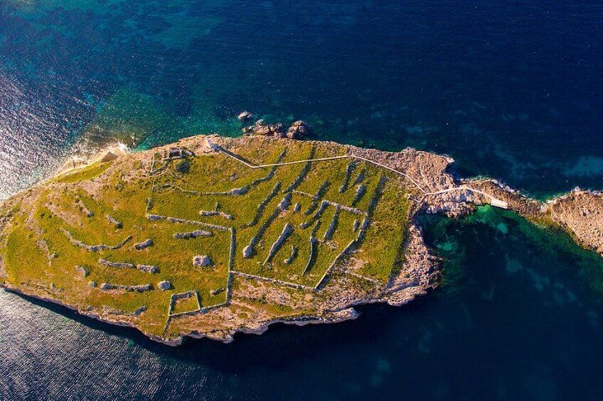 An aerial view of an island with distinct pathways and structures. 2