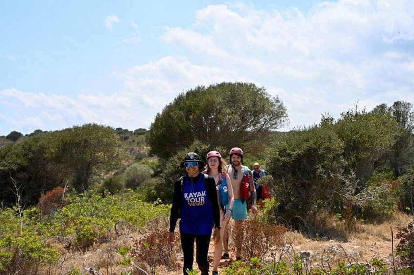 A group of people hiking in a natural, wooded area. 3