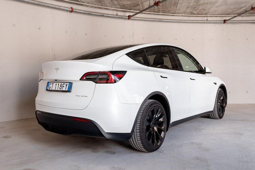 A white sports car parked in a garage. 4