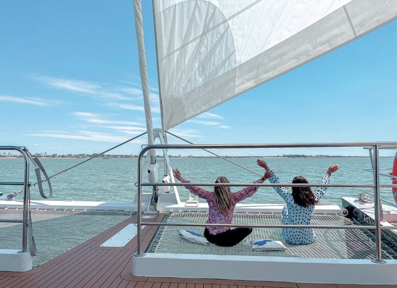A sailboat with two people enjoying the view. 3