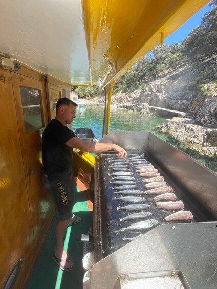 A person grilling fish on a boat. 3