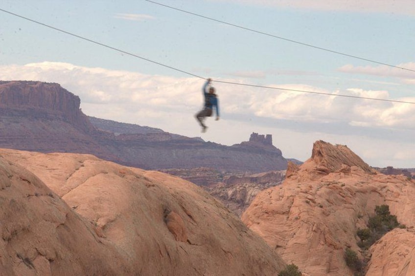 A person bungee jumping with a mountainous landscape in the background. 5
