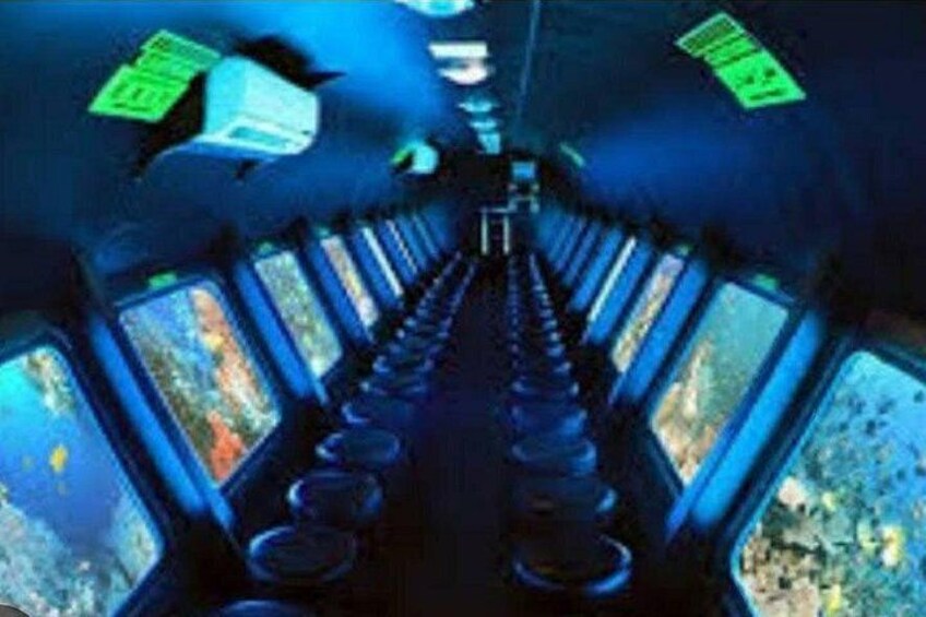 A corridor with multiple monitors and control panels. 3