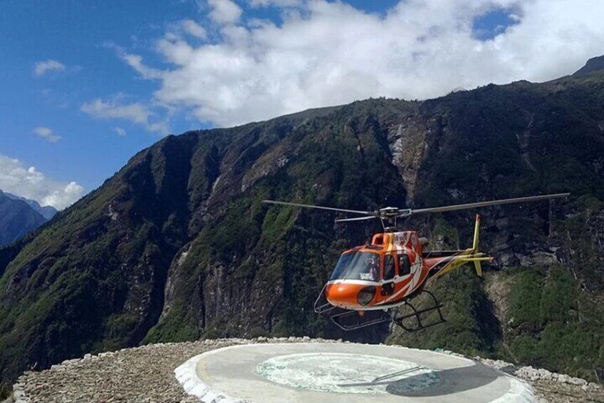 A helicopter hovering over a mountainous landscape with a clear sky. 3