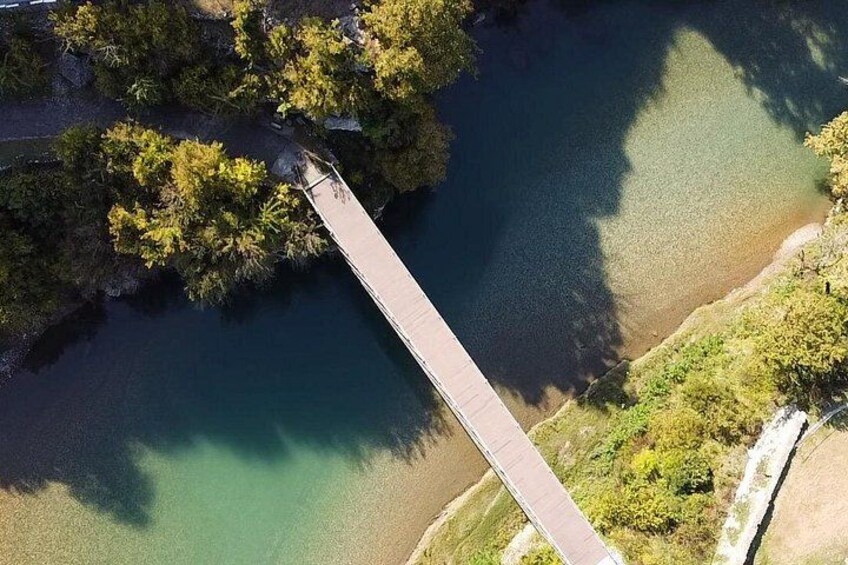 A bridge over a river with surrounding greenery. 3