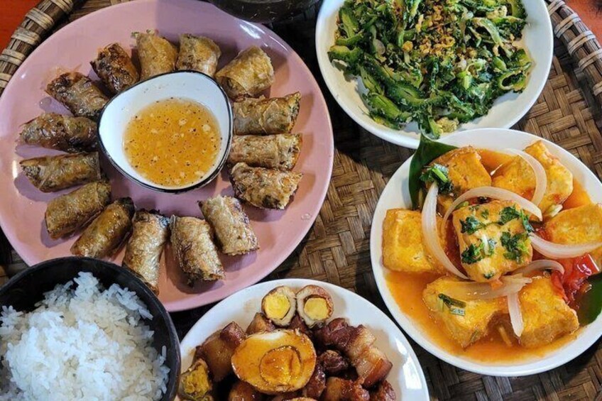 A variety of dishes including fried items, a bowl of rice, and a dish with tofu and onions. 4