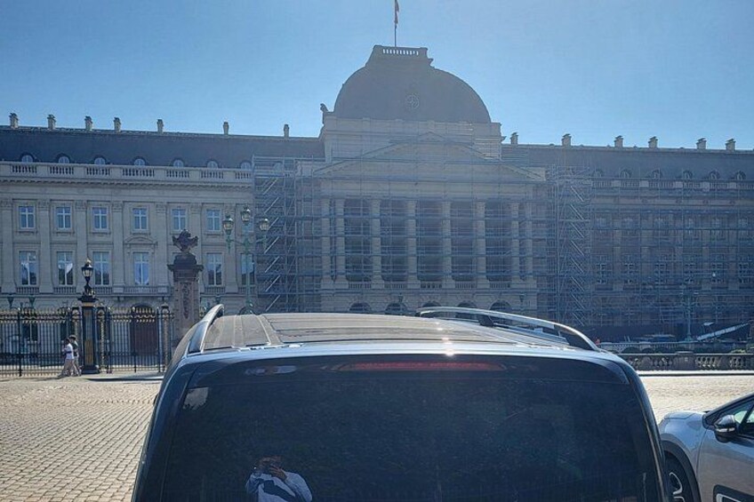 A car parked in front of a large building with a dome and scaffolding. 5