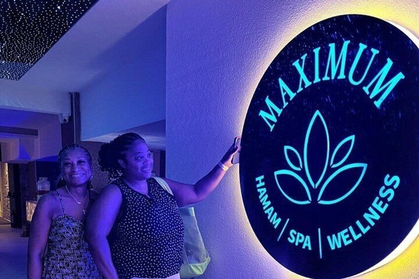 A sign with the words 'MAXIMUM HAWAII SPA WELLNESS' and a lotus flower symbol. 4