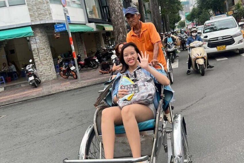 A person in a wheelchair on a street with motorcycles and cars. 1