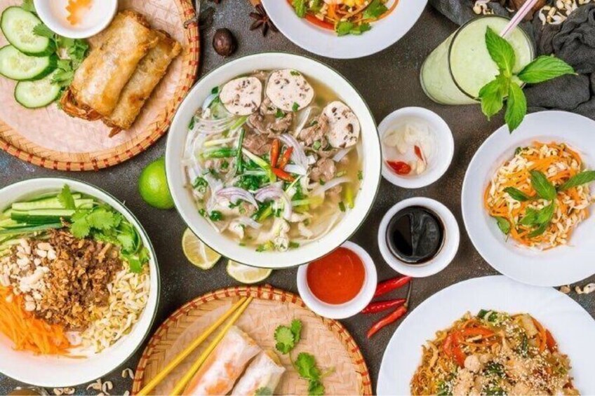 A variety of Vietnamese dishes including spring rolls, noodle soup, and rice noodle dishes. 5