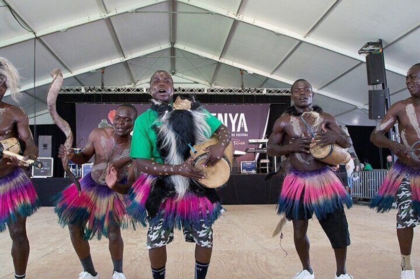 A group of people performing a traditional dance with colorful skirts and drums. 4