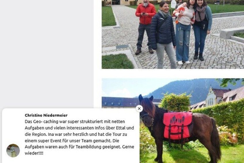 A group of people standing on a cobblestone path, a horse with a red blanket, and a scenic mountainous background. 2