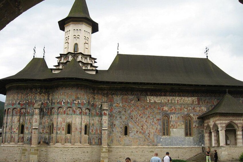 A historic building with a tower, detailed facade, and arched windows. 3