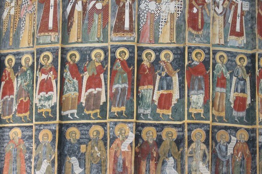 A mosaic with religious figures, each with halos and dressed in historical attire. 2