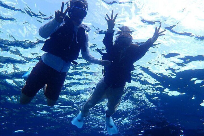 Two people scuba diving underwater. 5