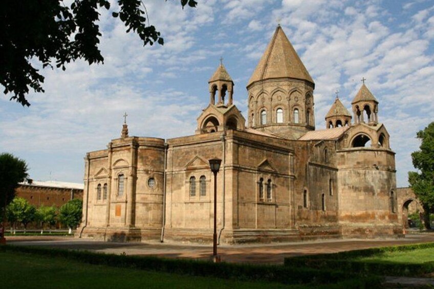 A historic church with a central dome and multiple smaller domes, surrounded by a well-maintained lawn. 5
